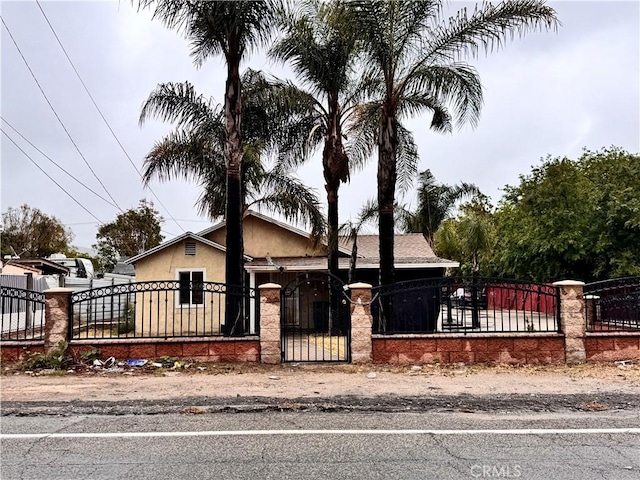 3083 N Macy St, San Bernardino, CA 92407 - view of front of home featuring a gate, a fenced front yard, and stucco siding