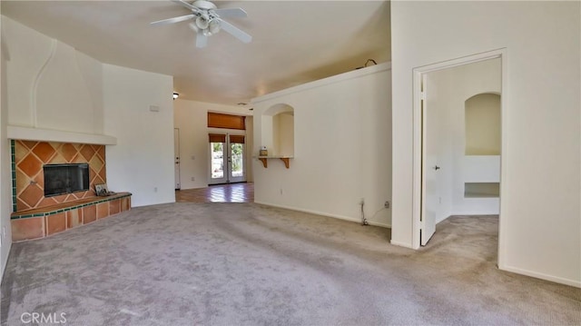 9630 El Mirador Blvd, Desert Hot Springs, CA 92240 - unfurnished living room featuring ceiling fan, carpet flooring, baseboards, and a tiled fireplace