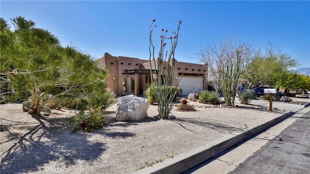9630 El Mirador Blvd, Desert Hot Springs, CA 92240 - pueblo-style home with a garage and stucco siding