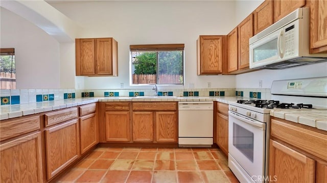 9630 El Mirador Blvd, Desert Hot Springs, CA 92240 - kitchen with a sink, tile countertops, white appliances, and a healthy amount of sunlight