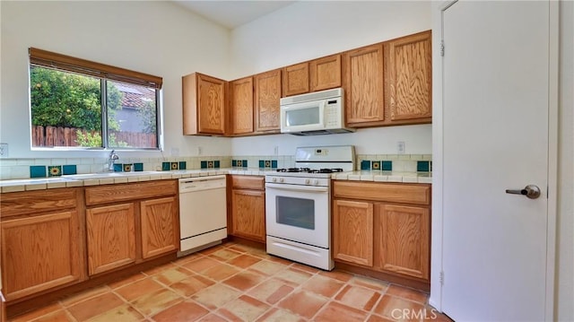 9630 El Mirador Blvd, Desert Hot Springs, CA 92240 - kitchen with white appliances, brown cabinets, and a sink