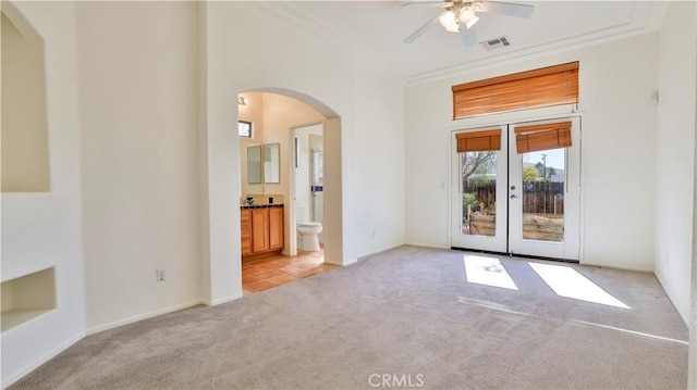 9630 El Mirador Blvd, Desert Hot Springs, CA 92240 - empty room with light carpet, arched walkways, french doors, a ceiling fan, and visible vents
