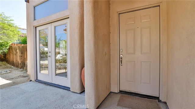 9630 El Mirador Blvd, Desert Hot Springs, CA 92240 - doorway to property featuring stucco siding, french doors, and fence