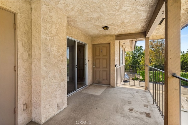 view of patio featuring a balcony