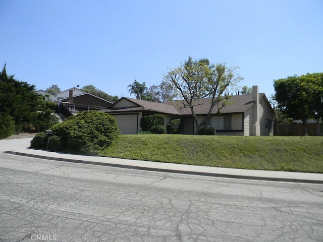 6045 Promontory Ln, Riverside, CA 92506 - single story home with an attached garage and a front lawn
