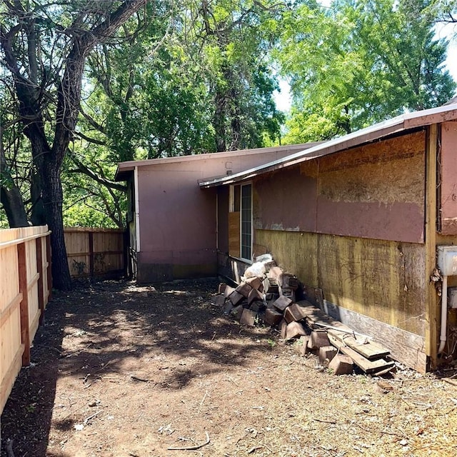 view of property exterior featuring fence