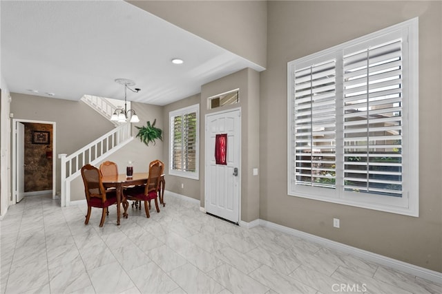 dining room featuring baseboards, recessed lighting, marble finish floor, and a chandelier