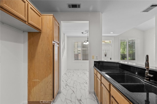 27017 Big Rpds Unit 37, Valencia, CA 91354 - kitchen featuring light marble finish floors, dark stone counters, and recessed lighting