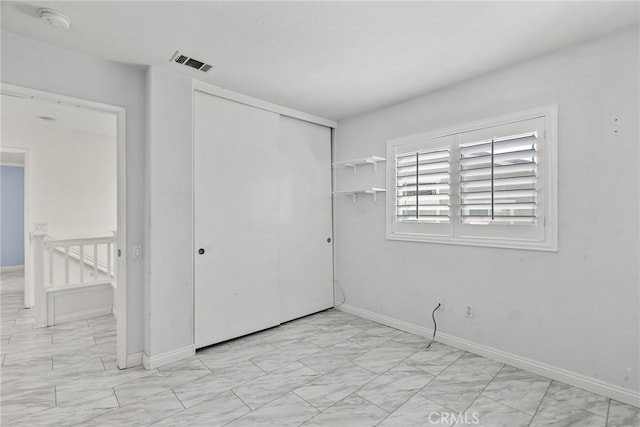 27017 Big Rpds Unit 37, Valencia, CA 91354 - unfurnished bedroom with a closet and light marble finish flooring