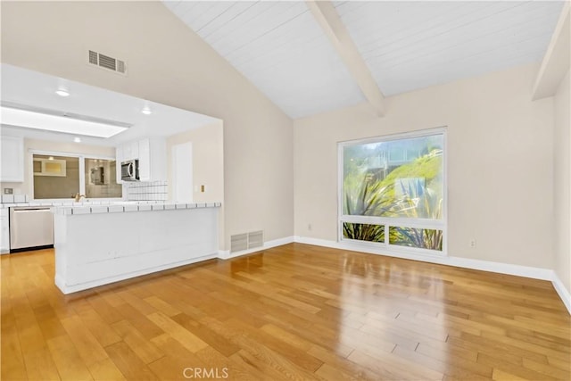 unfurnished living room featuring light wood-style flooring and baseboards
