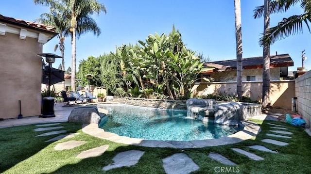 view of swimming pool featuring a yard, a fenced in pool, and a fenced backyard