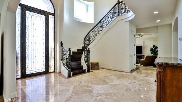 8531 10th St, Downey, CA 90241 - entryway with arched walkways, stairway, recessed lighting, and a towering ceiling