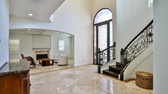 8531 10th St, Downey, CA 90241 - entryway with a towering ceiling, a fireplace, stairway, recessed lighting, and light marble finish floors