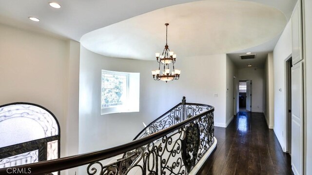 8531 10th St, Downey, CA 90241 - hallway with healthy amount of natural light, a chandelier, recessed lighting, dark wood finished floors, and an upstairs landing