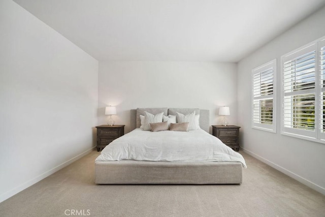 carpeted bedroom with baseboards