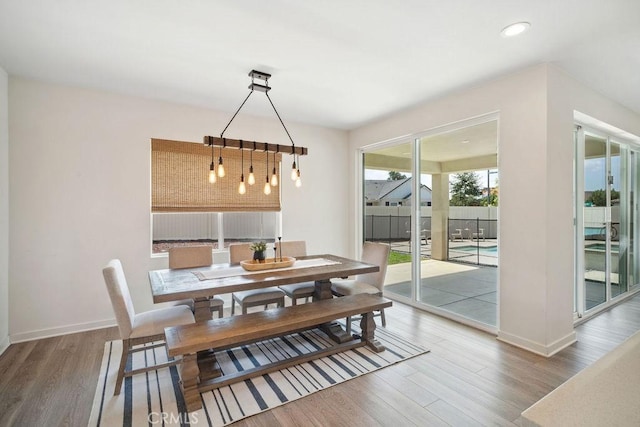 dining space with recessed lighting, baseboards, and wood finished floors