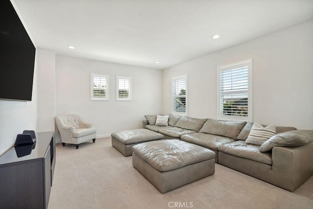 living area featuring recessed lighting, baseboards, and light colored carpet