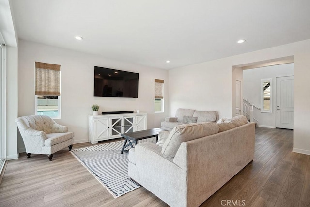 living room with recessed lighting, plenty of natural light, and wood finished floors