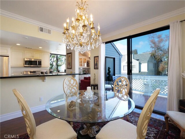 1150 W Capitol Unit 32, San Pedro, CA 90732 - dining area with visible vents, dark wood-style flooring, crown molding, and an inviting chandelier