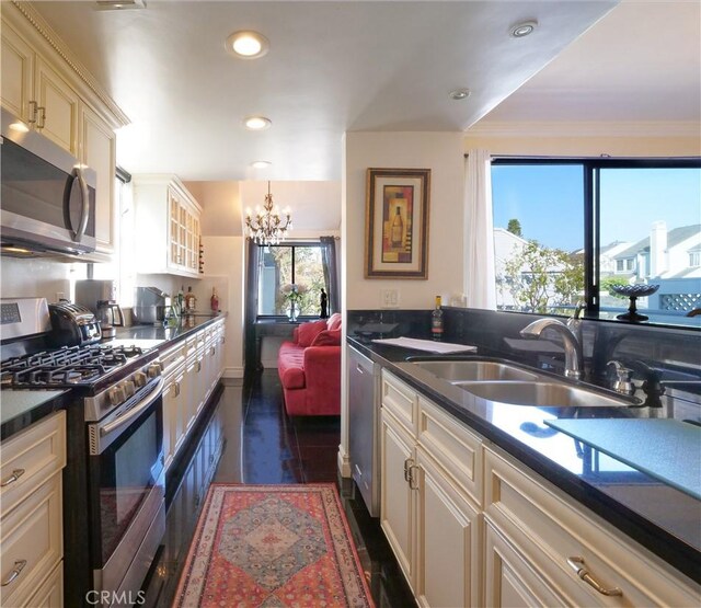 1150 W Capitol Unit 32, San Pedro, CA 90732 - kitchen featuring an inviting chandelier, a sink, appliances with stainless steel finishes, and dark countertops