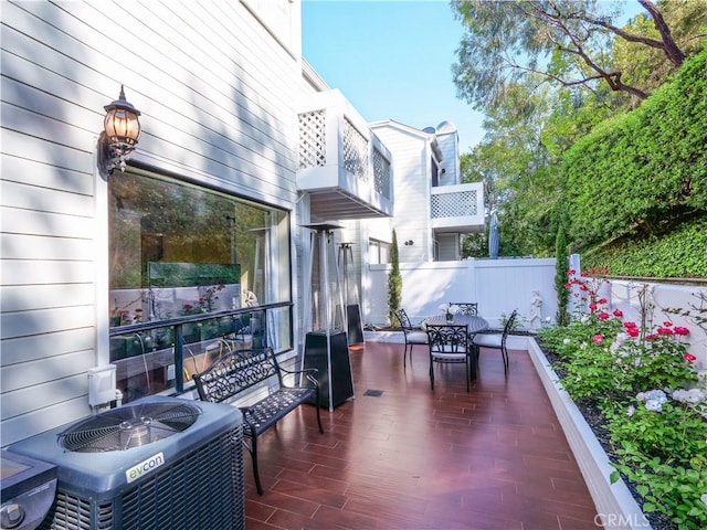 1150 W Capitol Unit 32, San Pedro, CA 90732 - view of patio / terrace with central air condition unit, fence, outdoor dining space, and a balcony