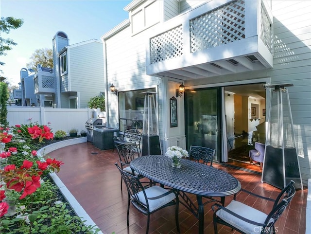 1150 W Capitol Unit 32, San Pedro, CA 90732 - rear view of house with fence, a balcony, and outdoor dining space