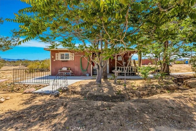 rear view of house with fence and a patio area