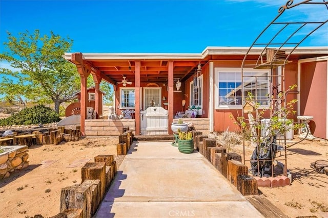 exterior space with ceiling fan