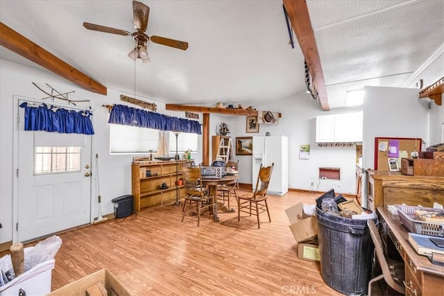 dining room featuring ceiling fan, beam ceiling, and light wood finished floors