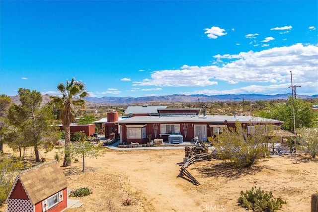 back of property featuring a mountain view