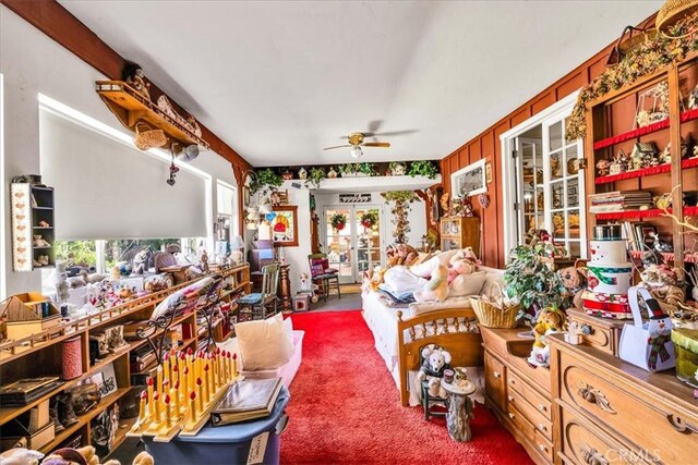 interior space with carpet floors, a ceiling fan, and french doors
