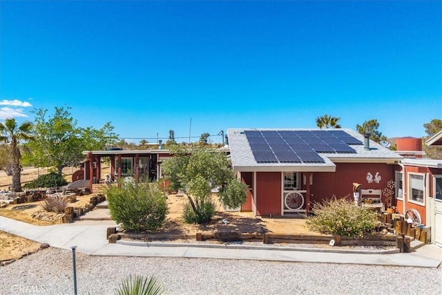 ranch-style home featuring solar panels