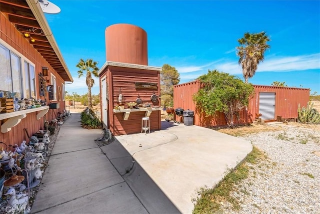 view of patio / terrace featuring an outbuilding