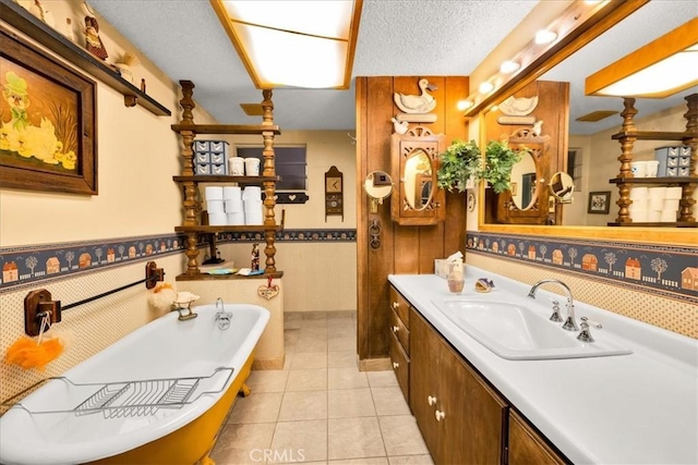 bathroom with vanity, a freestanding tub, tile patterned floors, and a wainscoted wall