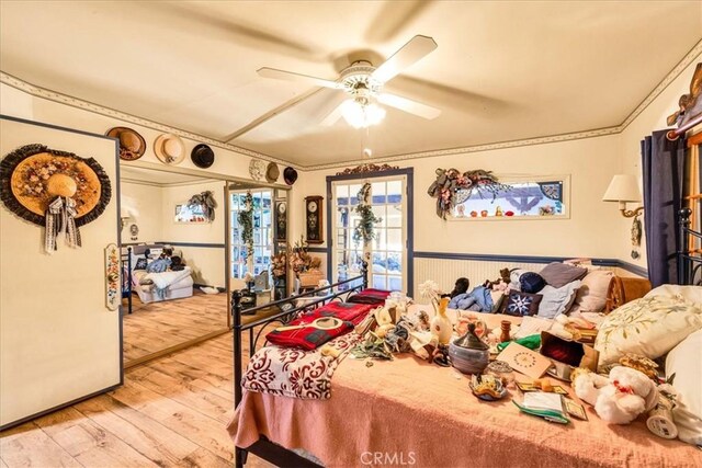 bedroom with wood-type flooring and ceiling fan