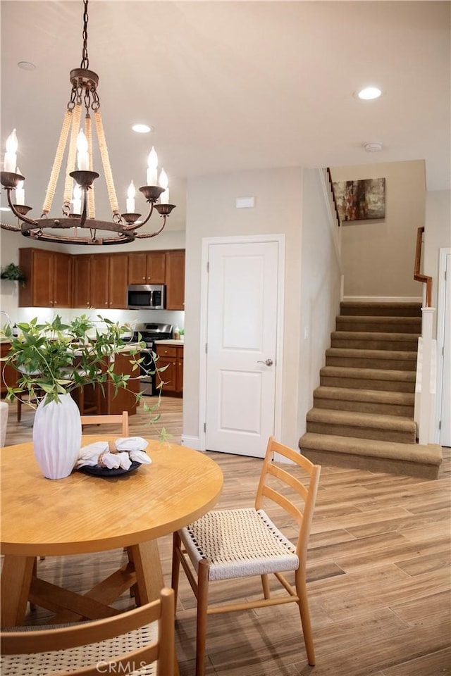 9369 Riberena Cir Unit 11, Atascadero, CA 93422 - dining area with a chandelier, light wood-style flooring, stairs, and recessed lighting