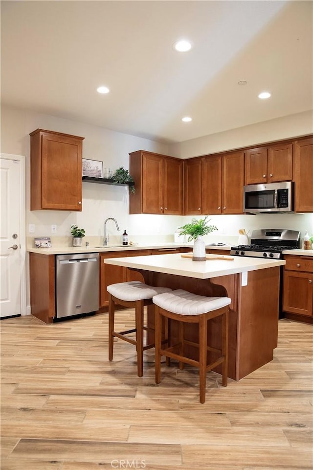 9369 Riberena Cir Unit 11, Atascadero, CA 93422 - kitchen featuring stainless steel appliances, open shelves, light countertops, light wood finished floors, and recessed lighting