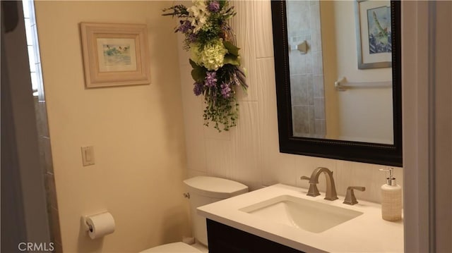 3615 Towhee Court, Punta Gorda, FL 33950 - bathroom featuring toilet, vanity, and decorative backsplash