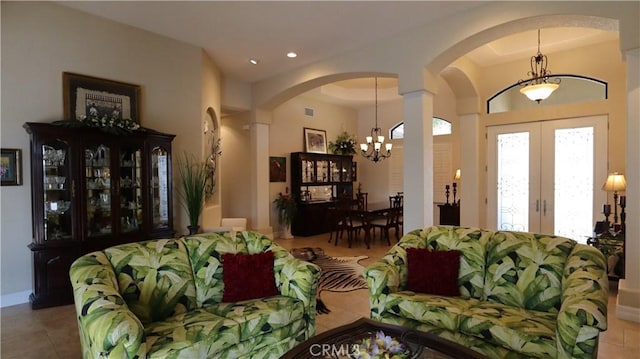 3615 Towhee Court, Punta Gorda, FL 33950 - living room featuring an inviting chandelier, arched walkways, french doors, and tile patterned floors