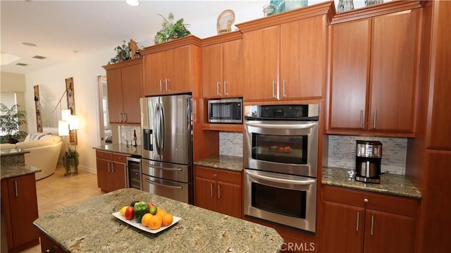 3615 Towhee Court, Punta Gorda, FL 33950 - kitchen featuring open floor plan, stainless steel appliances, tasteful backsplash, and beverage cooler