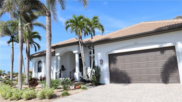 3615 Towhee Court, Punta Gorda, FL 33950 - view of front of home featuring an attached garage, stucco siding, a tiled roof, and driveway