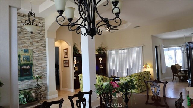 3615 Towhee Court, Punta Gorda, FL 33950 - dining room with an inviting chandelier, tile patterned flooring, baseboards, and arched walkways