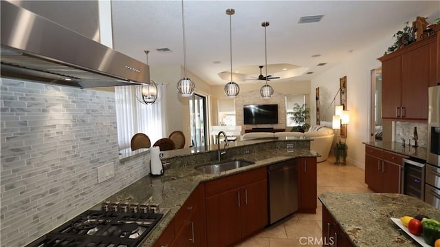 3615 Towhee Court, Punta Gorda, FL 33950 - kitchen with light tile patterned floors, a sink, wall chimney exhaust hood, backsplash, and appliances with stainless steel finishes
