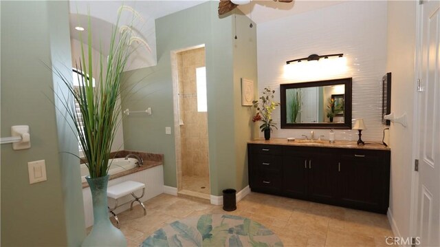 3615 Towhee Court, Punta Gorda, FL 33950 - bathroom featuring a stall shower, a ceiling fan, baseboards, a bath, and vanity