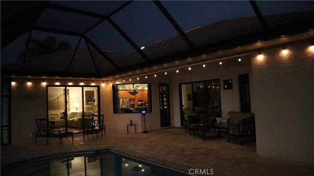 3615 Towhee Court, Punta Gorda, FL 33950 - patio at night with an outdoor hangout area, an outdoor pool, and a lanai