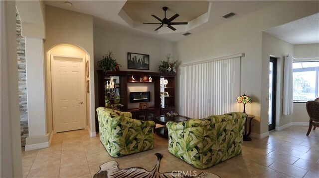 3615 Towhee Court, Punta Gorda, FL 33950 - living room featuring a tray ceiling, light tile patterned floors, visible vents, and a ceiling fan