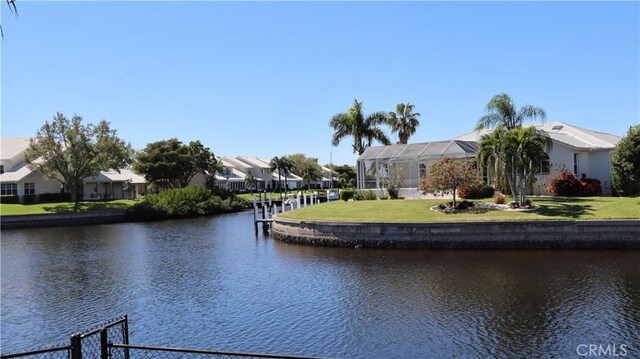 3615 Towhee Court, Punta Gorda, FL 33950 - view of dock with a water view, a residential view, and a lawn