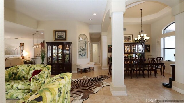 3615 Towhee Court, Punta Gorda, FL 33950 - tiled living room featuring recessed lighting, baseboards, an inviting chandelier, arched walkways, and ornate columns