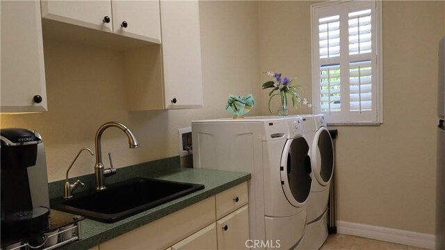 3615 Towhee Court, Punta Gorda, FL 33950 - clothes washing area with a sink, cabinet space, washer and dryer, light tile patterned floors, and baseboards