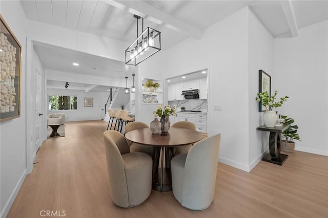 dining room with recessed lighting, beamed ceiling, baseboards, and light wood-type flooring